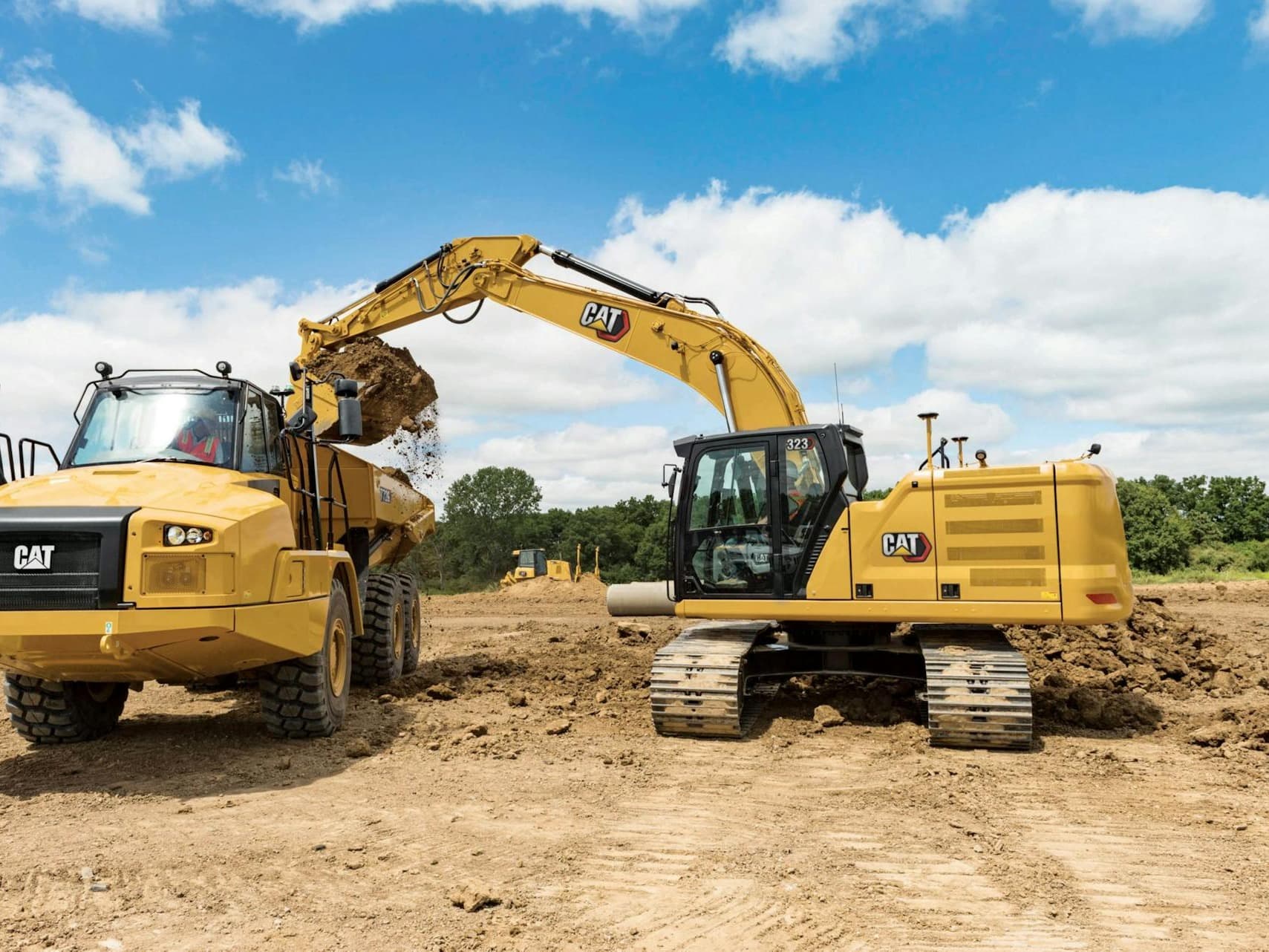 323 excavator loading an articulated truck